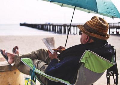 A man reading by the sea